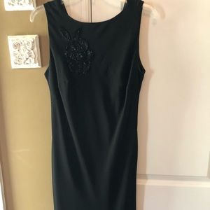 Black cocktail dress with beaded embellishments.